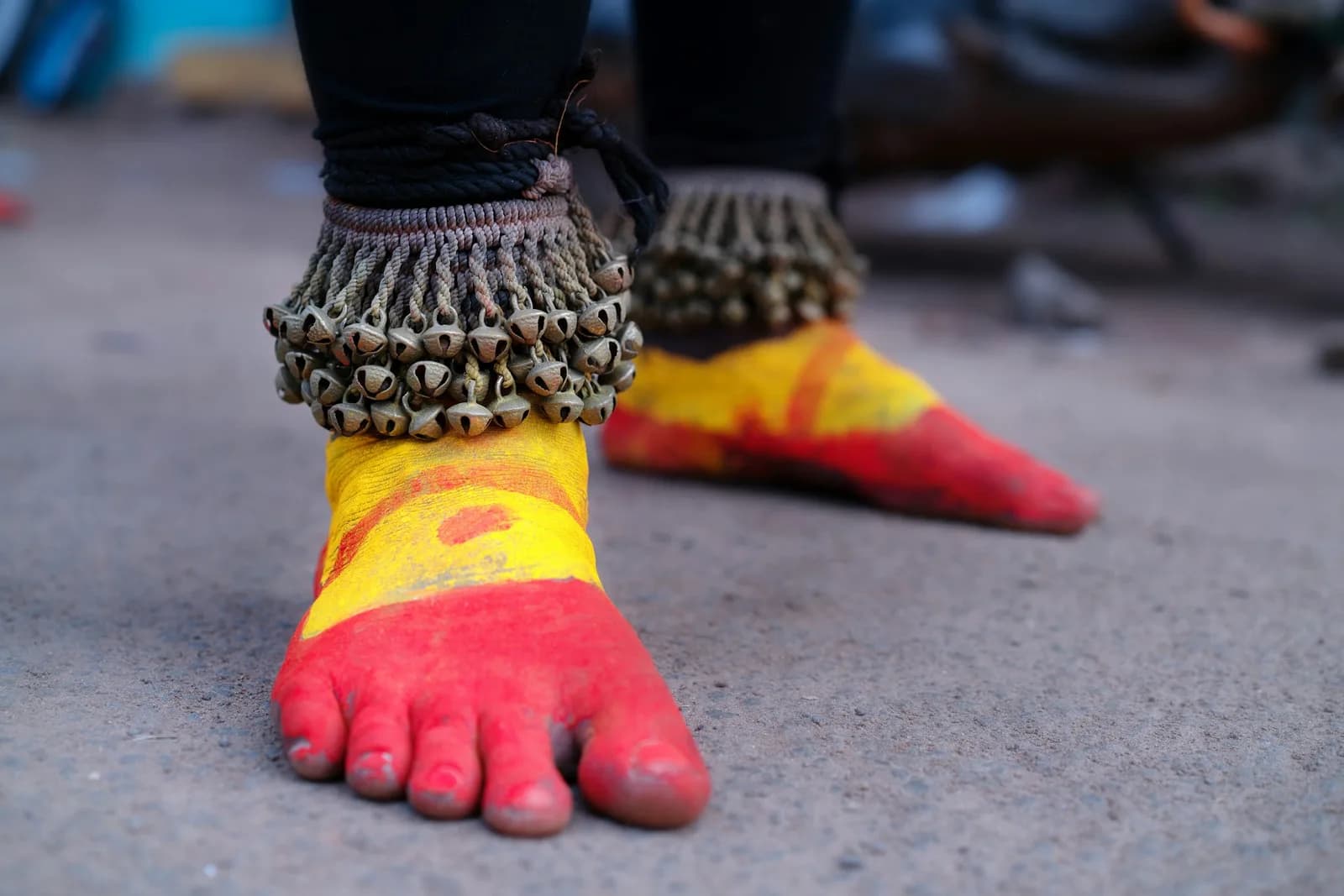 Layered Kundan Anklet - Feet painted red and yellow with traditional bell anklets