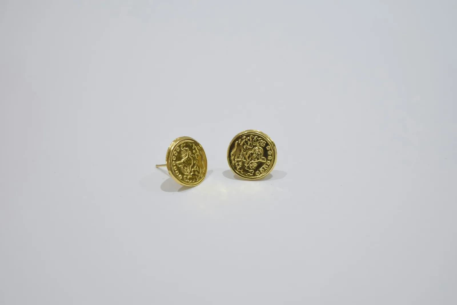 Kundan Polki Diamond Earrings - Two gold oval earrings with intricate designs