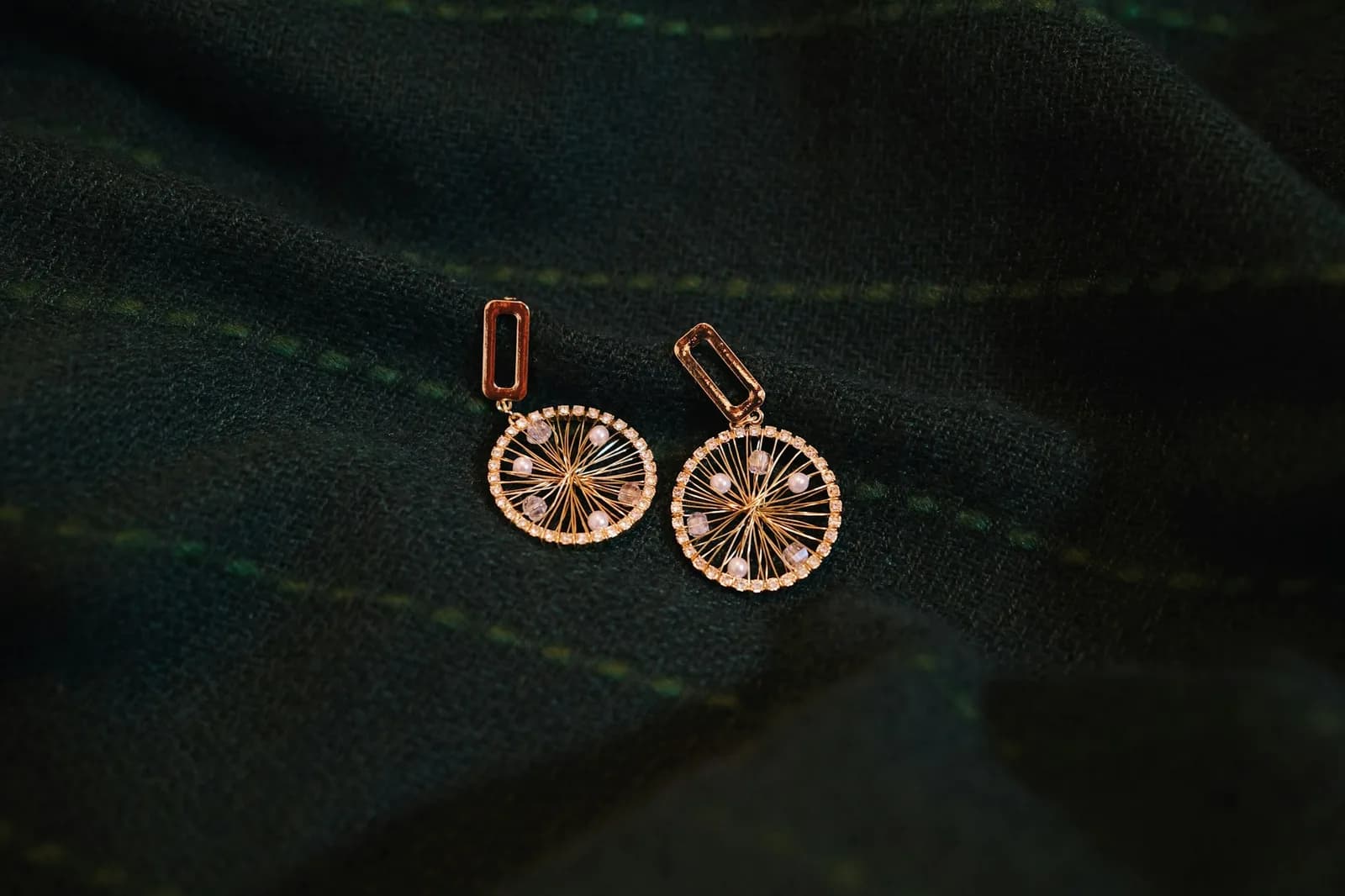 Drop Polki Diamond Earrings - A pair of earrings sitting on top of a green cloth