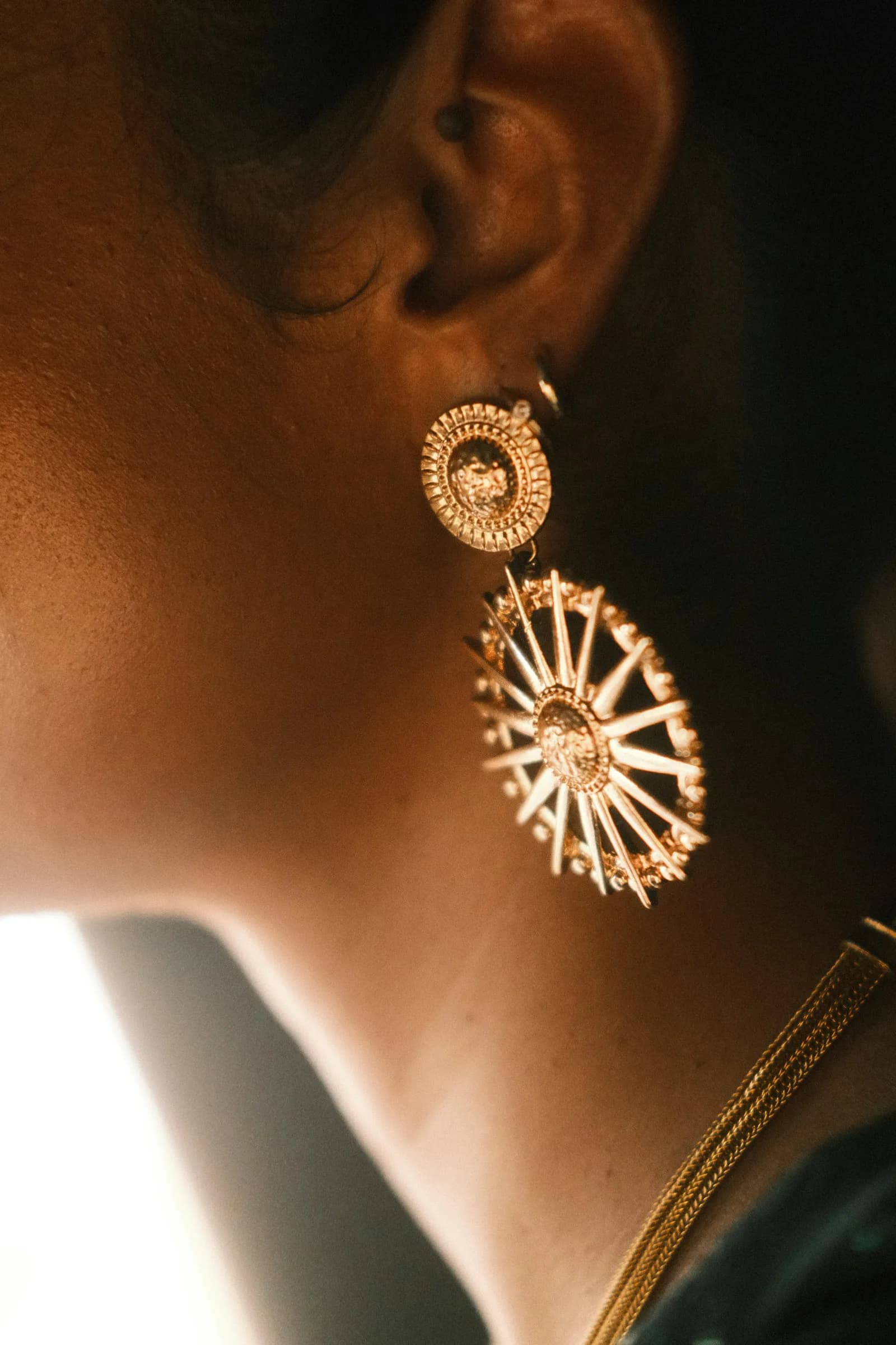 Nakshi Kundan Earrings - A close up of a person wearing a pair of earrings