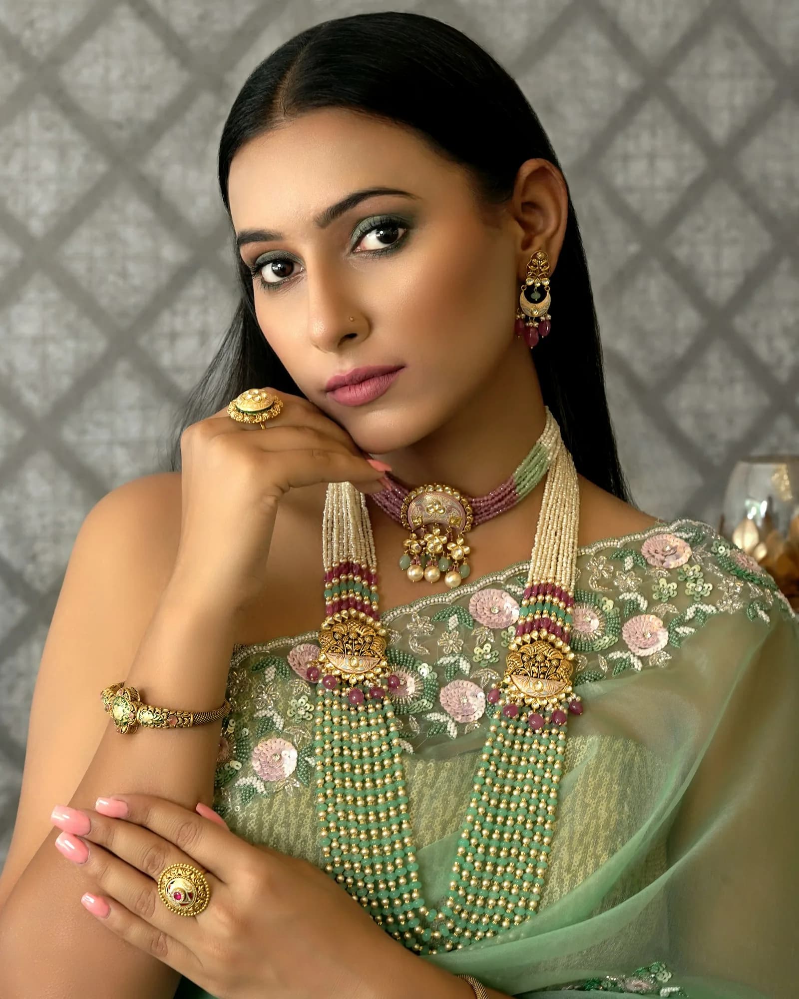 Woman wearing a green sari and jewellery
