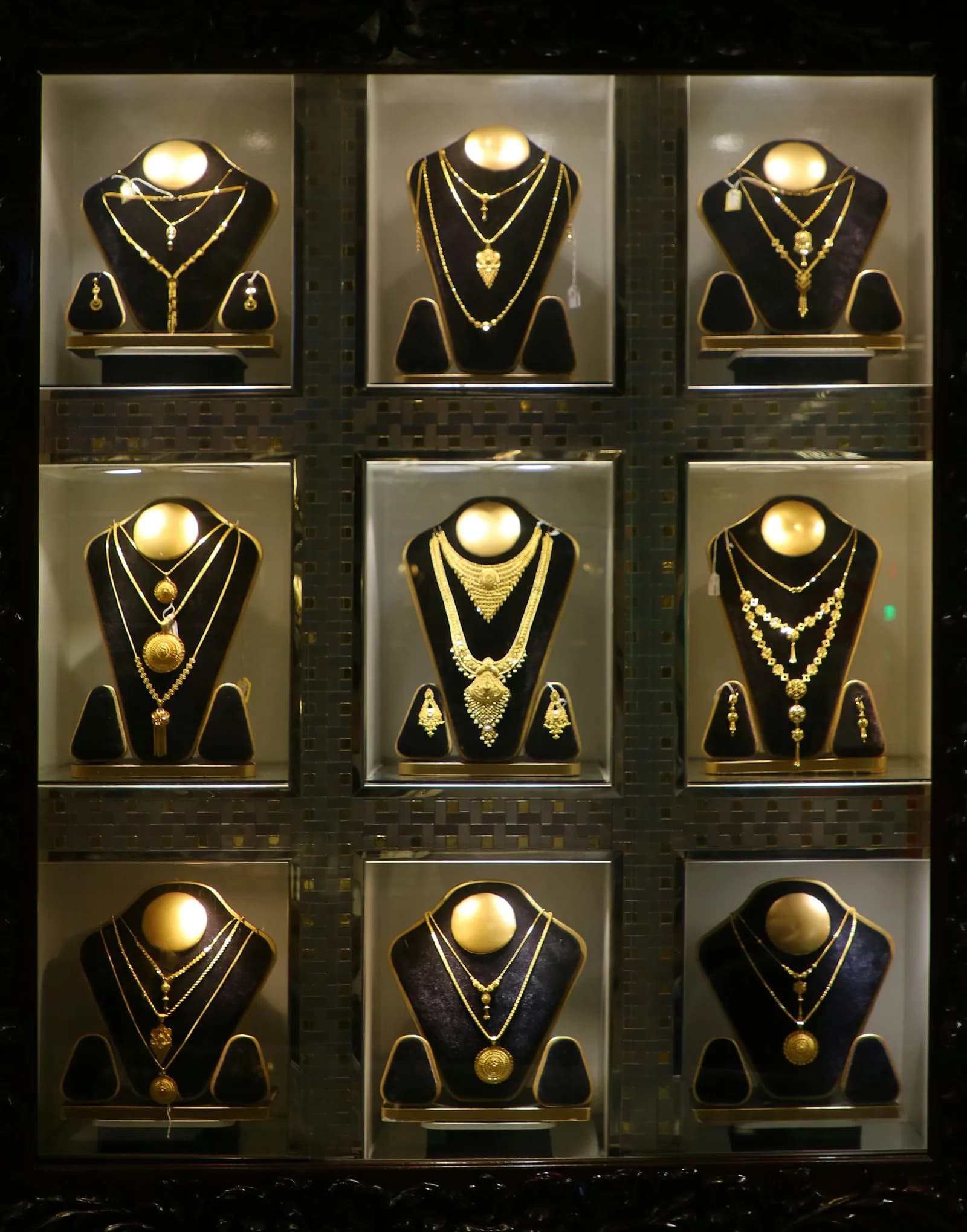 Filigree Rose Gold Necklace - Collection of gold necklaces displayed in a store