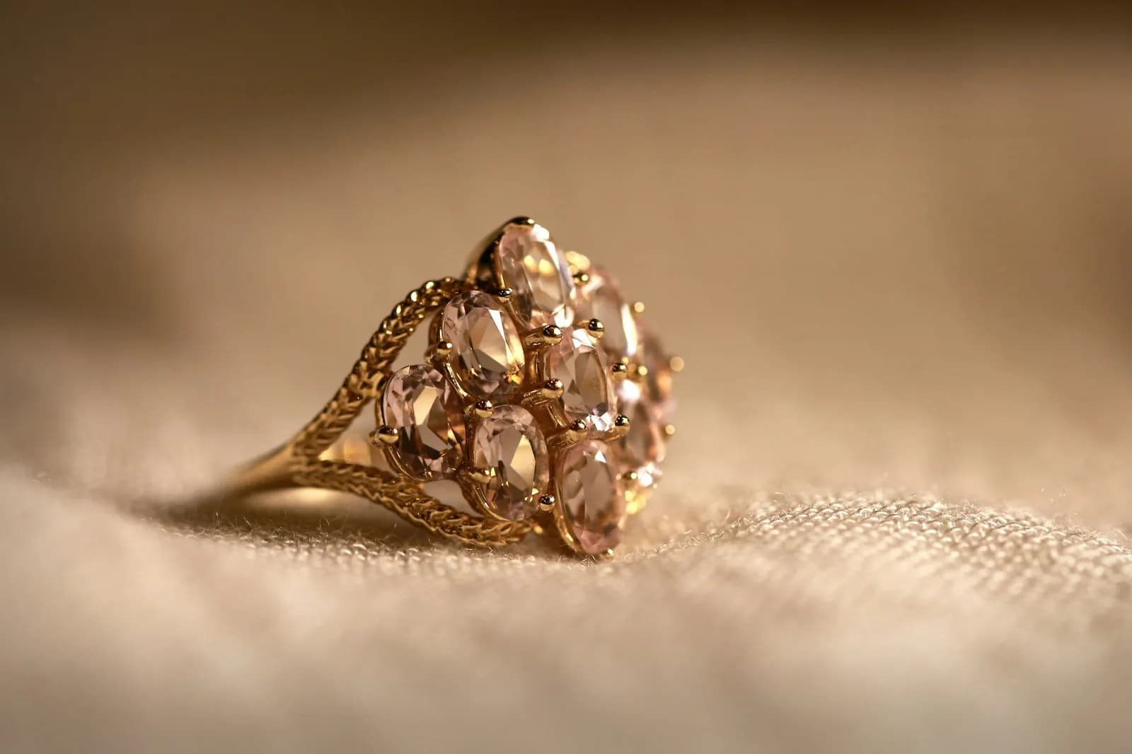 Solitaire 18K Gold Ring - Gold diamond studded ring on white textile